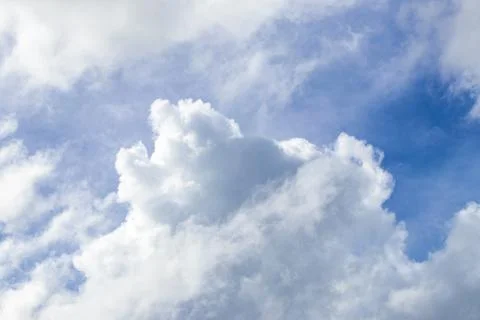 Soft cirrus clouds floating gracefully across bright tropical blue heavens .. Stock Photos