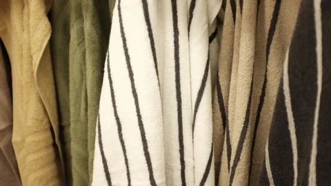 Soft clean folded towels hanging on a hook. Colorful towels in a  laundry room Stock Footage 320971715