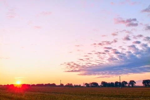 A soft cloud background with a pastel colored orange and pink to blue Stock Photos