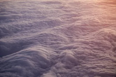 Soft clouds from above at sunset Stock Photos