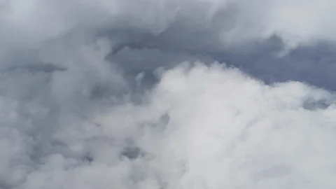 Soft clouds drift beneath the airplane wing Video stock 318742064