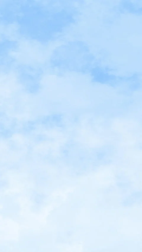 Soft clouds drift gently across a serene, pale blue sky Stock Footage 336693843