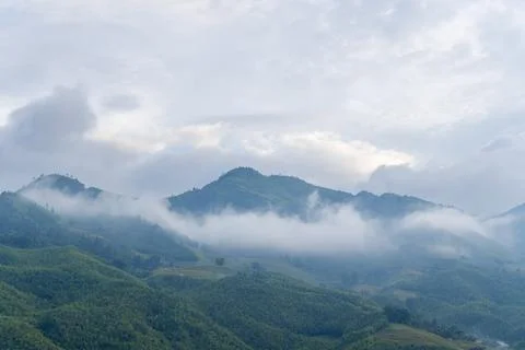Soft clouds drifting over green Sapa mountains Stock Photos