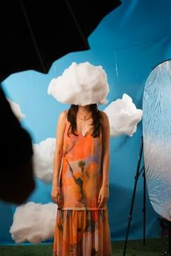 Soft clouds float above a woman's head Stock Photos