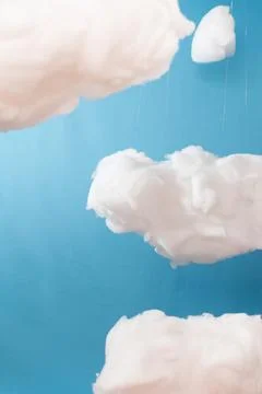 Soft clouds float gently against a calm blue sky Stock Photos
