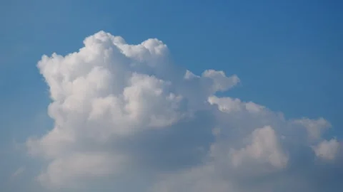 Soft clouds gracefully drift across a bright blue sky Stock Footage 331463793
