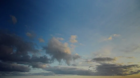 Soft clouds invading the sky at dawn in timelapse. Bluish and golden colors. Stock Footage 87359785