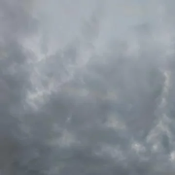 Soft cloudy sky with subtle light rays Stock Photos