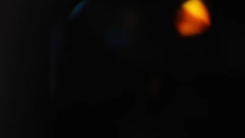 Soft colorful bokeh drifting over a black background with smooth optical gl.. Stock Footage 341324922