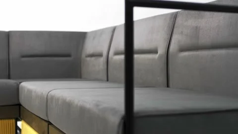 Soft comfortable cushions of a corner sofa made of gray textile Stock Footage 219583337