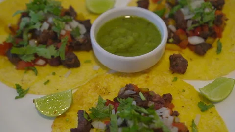 Soft corn tortilla taco hand eating salsa green jelapeno sauce Mexican food 4 Stock Footage 306220423