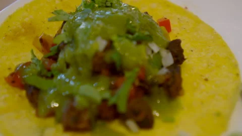 Soft corn tortilla taco hand eating salsa green jelapeno sauce Mexican food.. 스톡 동영상 306220428