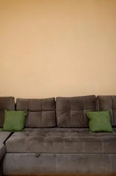 A soft corner sofa with carriage coupler and a clean, solid wall for copyrigh Stock Photos