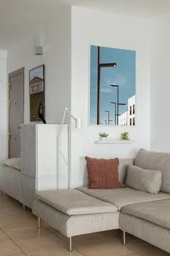 Soft corner sofa with pillows and lamp in luxury apartment Фото