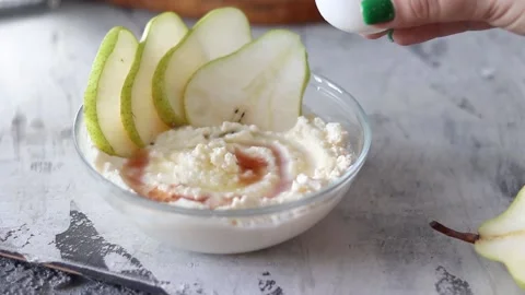 Soft cottage cheese with pear in a white plate Stock Footage 156030769