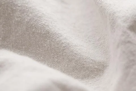 Soft cotton fabric texture close-up. Natural beige color with weave pattern.  Stock Photos