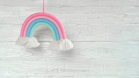 Soft Cotton Rainbow Toy Spinning against a Wooden White Wall. Stock Footage 238528271