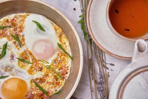 Soft creamy omlette scrambled eggs in cast iron skillet Stock Photos