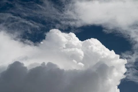 Soft cumulus clouds over deep sky gentle light, fluffy texture, serene atmosp Stock Photos