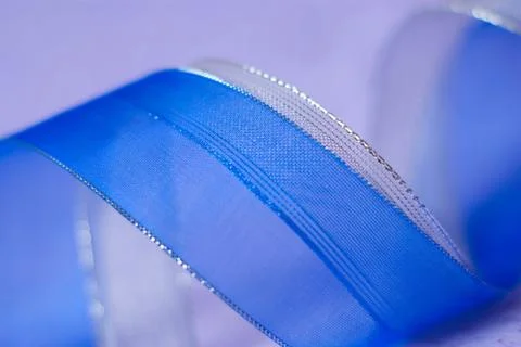 Soft defocused background blue silver ribbon on violet  paper texture Stock Photos