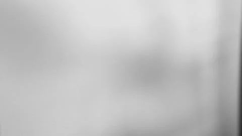 Soft diffused light illuminates a textured wall, creating subtle shadows and a Stockbeeldmateriaal 318610911