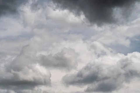 Soft dramatic cloudscape with layered tones, airy cumulus sitting over textur Stock Photos