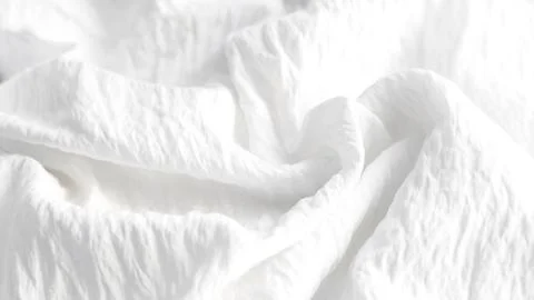 Soft draped white fabric texture background. Stock Photos