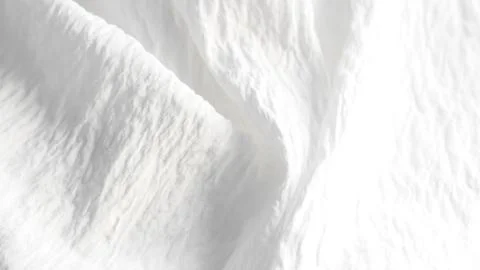 Soft draped white fabric texture background. Stock Photos
