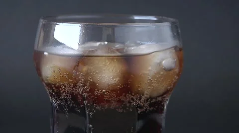 Soft drink, bubbless, ice on dark background. Video stock 49070731