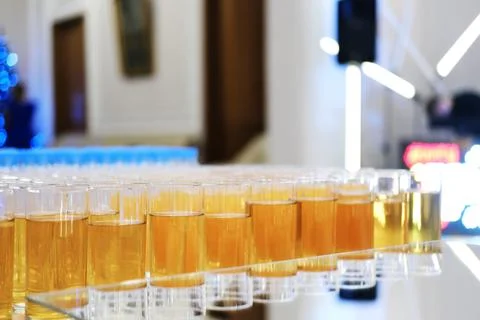 Soft drinks, juices stand in a row on the buffet table Stock Photos