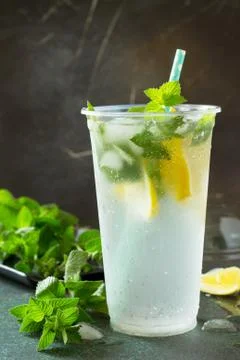 Soft drinks. Refreshing summer drink lemon with mint and ice. Stock Photos