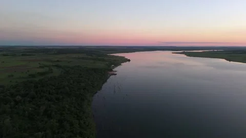 Soft evening aerial view over a calm winding Paraná River in pastel sunset and Vídeos de archivo 321866070