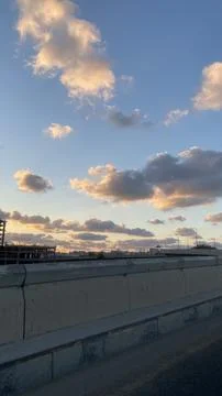 Soft Evening Clouds in Blue Sky Over Urban Rooftop 写真素材