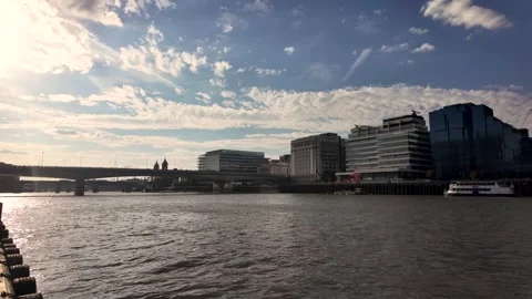 Soft evening light glows over London Bridge and stacked office blocks as gentle Stock Footage 341351496