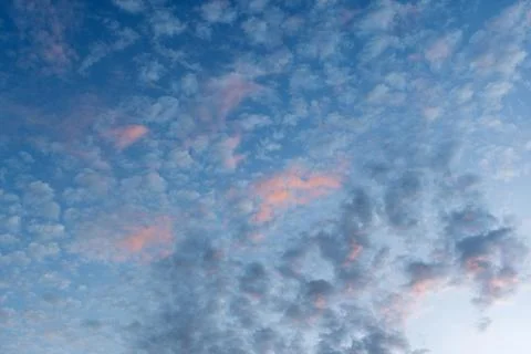 Soft evening sky with blue clouds and pink sunset glow forms calm airy Stock Photos