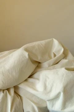 Soft fabric on a bed with simple design showing texture and folds in a neut.. 库存照片