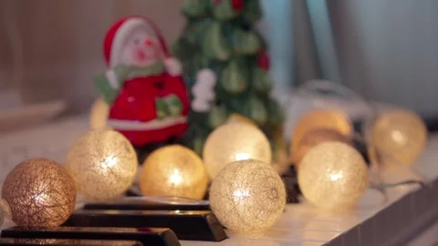 Soft Fading Garland String Lights on White Piano Keys 4K Stock Footage 339522767