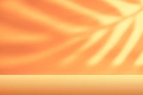 Soft flowing shadows on orange background with empty tabletop for autumn Ha.. Stock Photos
