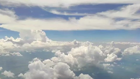 Soft fluffy clouds float across the blue sky. View from the porthole. View from Stock Footage 281271295