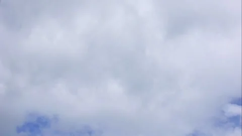 Soft fluffy clouds glide across the clear sky suggesting mindfulness freedom and Stock Footage 323439054