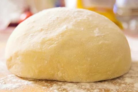 Soft fluffy dough with wheat flour on the table close-up Stock Photos