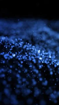 Soft-focus abstract particles glowing in blue, resembling a dust field or mag Stock Photos