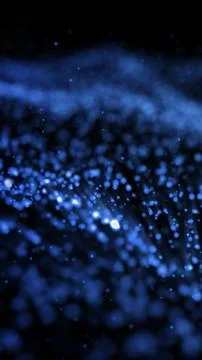 Soft-focus abstract particles glowing in blue, resembling a dust field or mag Stock Photos