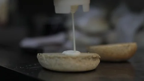 Soft Focus of Adding Mayo on a Burger Bread Stock Footage 129048917