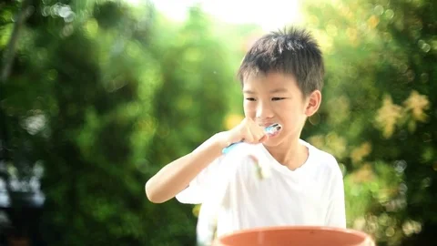 Soft focus and dramatic looks of young asian boy brush tooth Stock Footage 81885244
