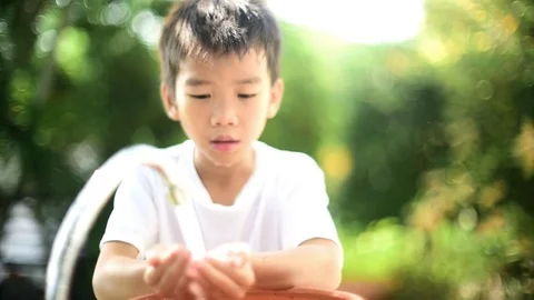 Soft focus and dramatic looks of young asian boy wash his face Stock Footage 85383194