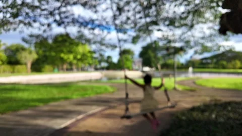Soft focus back view child girl on swing at park. Vídeo Stock 276692682