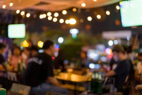 Soft focus background image of bar atmosphere and night light bokeh. Stock Photos
