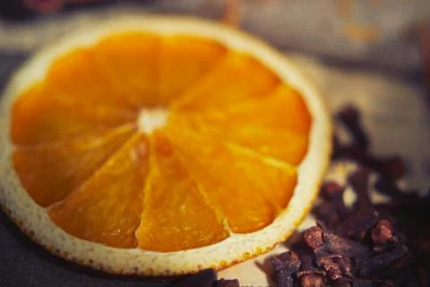 Soft focus background with orange and cloves on the linen fabric Stock Photos