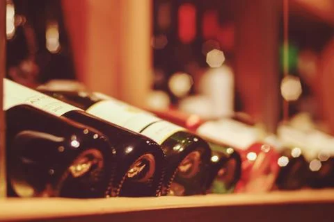 Soft focus background of wine stand with many bottles in wine shop or bar Stock Photos